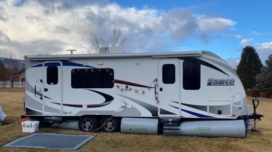 lance camper with rv skirts in summer