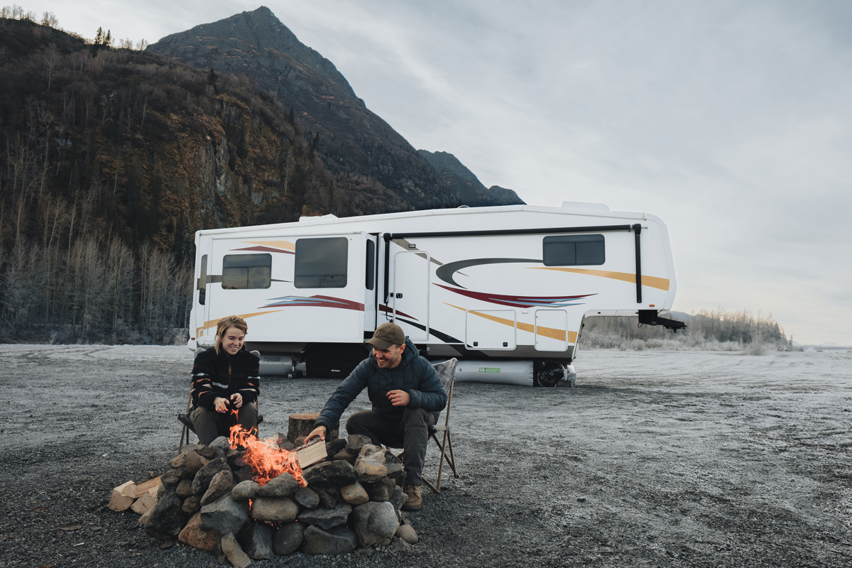 Couple in front of white fifth wheel